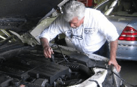 Man looking into a car engine